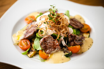 Brutus salad with beef tenderloin served on a plate