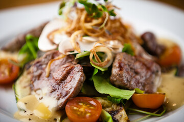 Brutus salad with beef tenderloin served on a plate