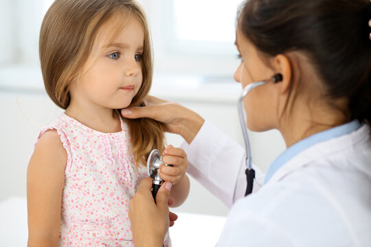 Doctor examining a little girl by stethoscope.