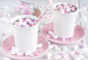 Mug of hot chocolate with marshmallow and heart shaped candies