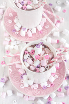 Mug of hot chocolate with marshmallow and heart shaped candies