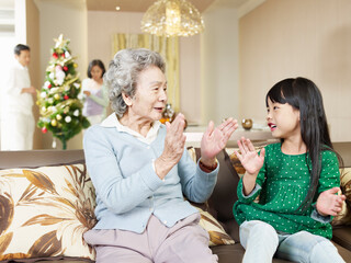 grandma and granddaughter playing at home