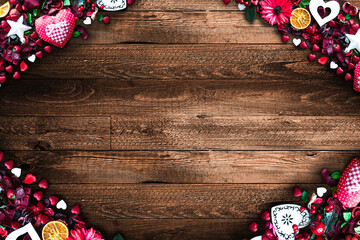 Valentine's Day Background with love themed elements like cotton and paper hearts, flowers, berries, oranges and other decorations. Wooden old parquet on the back.