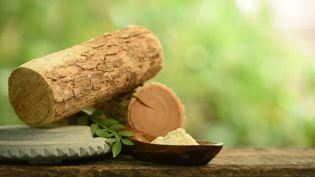 Thanaka or naringi crenulata woods ,powder and green leaves on nature background.