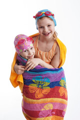 Girls wrapped in a towel on a white background