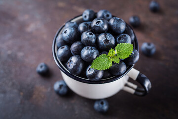 Freshly picked blueberries in a cup. Concept for healthy eating and nutrition.