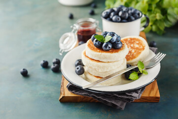 Cottage cheese pancakes with blueberries and mint, Food background with copy space