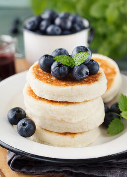Cottage cheese pancakes with blueberries and mint, close up. Healthy Breakfast. Selective focus