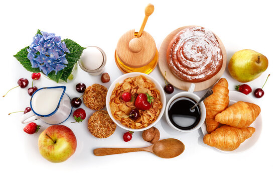 Breakfast fresh croissant coffee berry and honey. Still life of sweets and fruits top view, isolated white background.