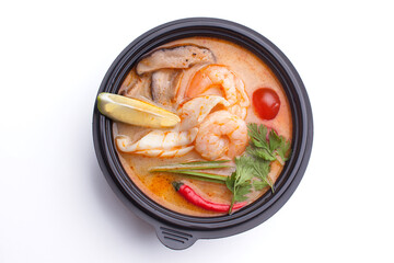 Miso soup in a black plastic plate on a white background