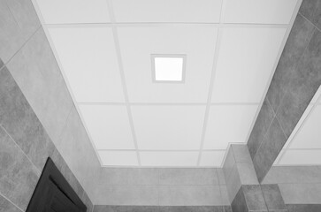 Fototapeta premium White ceiling with modern lighting in room, low angle view