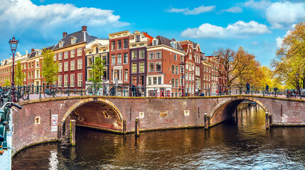 Channel in Amsterdam Netherlands Holland houses under river Amstel. Landmark old european city spring landscape.