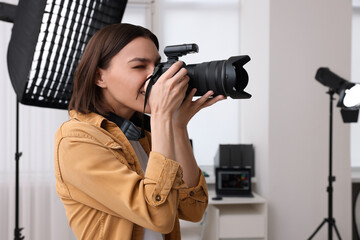 Professional photographer taking picture in modern photo studio