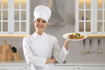 Portrait of professional chef presenting delicious dish in kitchen