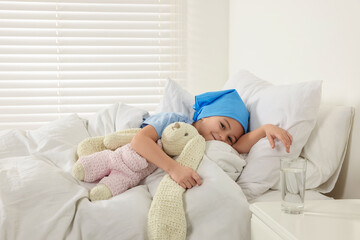 Obraz na płótnie Canvas Childhood cancer. Girl resting with toy bunny in hospital