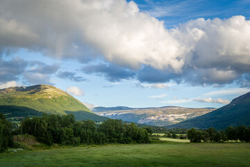 Hills, mountains and beautiful clouds at Norway nature landscape of rural destinations.