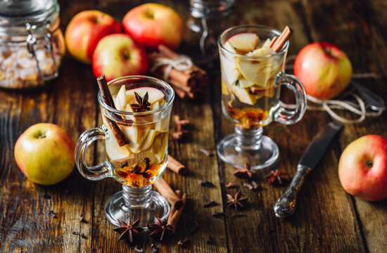 Homemade Spiced Beverage with Sliced Apples and Some Kitchen Herbs.