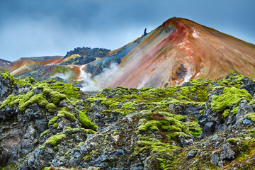 Valley National Park Landmannalaugar. On the gentle slopes of the mountains are snow fields and...