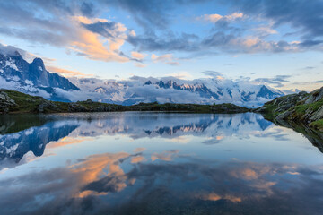 Mountains and sky reflected in Lac De Cheserys, Chamonix, France.