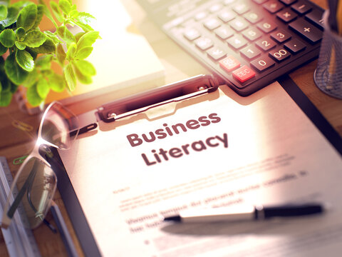 Business Literacy on Clipboard with Sheet of Paper on Wooden Office Table with Business and Office Supplies Around. 3d Rendering. Toned and Blurred Illustration.