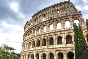 Fototapeta na wymiar view on the Great Roman Colosseum Coliseum, Colosseo ,also known as the Flavian Amphitheatre. Famous world landmark. Scenic urban landscape. Rome. Italy. Europe
