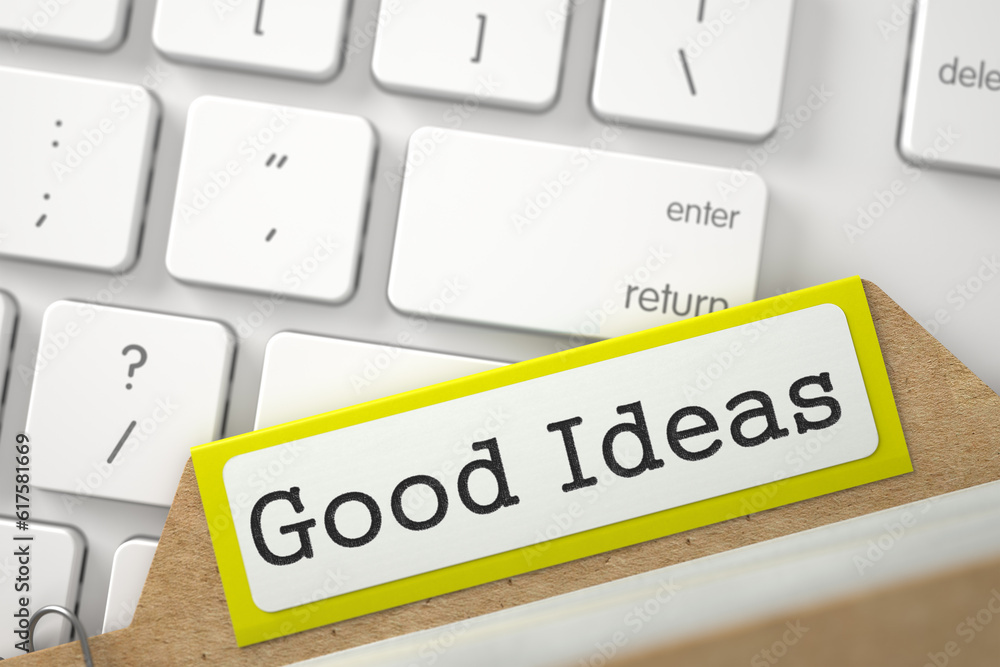 Poster good ideas written on yellow index card on background of white pc keyboard. closeup view. blurred il