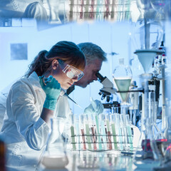 Health care researchers working in life science laboratory. Young female research scientist and...