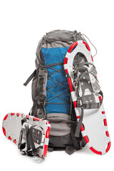 a pair of snowshoes and backpack traveler in the winter
