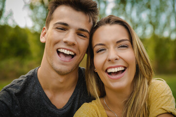 Fototapeta premium Portrait of a young beautiful couple laughing