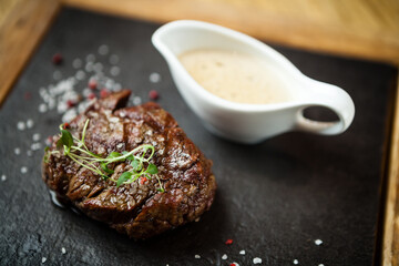 Filet mignon served on a stone board in restaurant