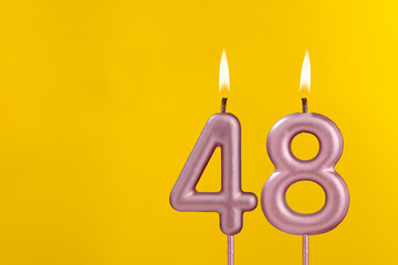 Birthday candle number 48 - Birthday celebration on yellow background