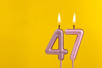 Candle 47 with flame - Birthday card on yellow luxury background