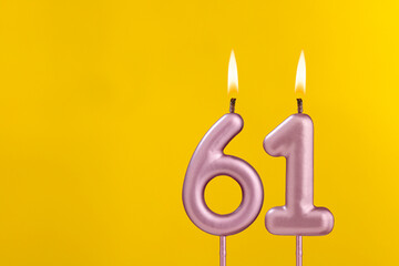 Candle 61 with flame - Birthday card on yellow luxury background