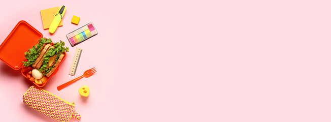 Lunch box of tasty food and school stationery on pink background with space for text