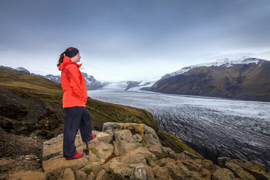A hiker admiring view of Fjallsarlon glacier in Southern Iceland