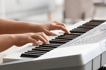 Fototapeta premium Woman playing modern synthesizer, closeup