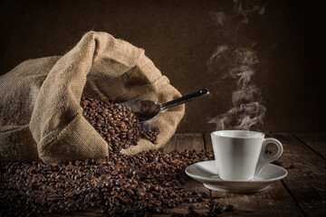 Background of cup of coffee beans with jute bag and bailer