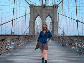 Tourist woman on the Brooklyn Bridge in New York City