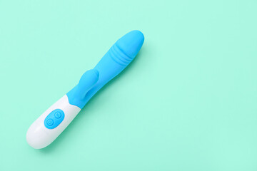 Vibrator from sex shop on turquoise background