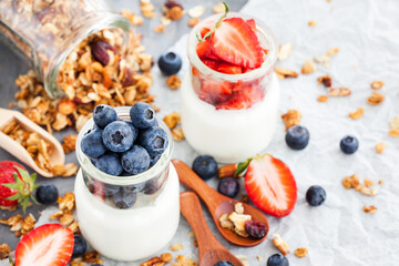 Delicious plain yogurt with fresh blueberry and strawberry in a glass jars for breakfast