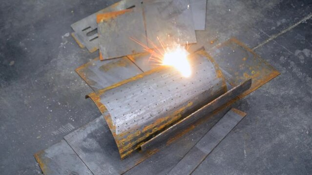 Laser cleaning of metal. Industrial laser cleaning rust of metal. Industrial removal of rust of metal surface with laser beam. Man cleaning surface from corrosion with laser metal cleaning machine