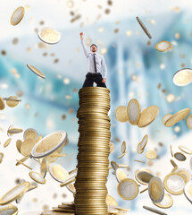 Happy businessman exults over a stack of golden coins