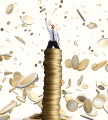 Happy businessman exults over a stack of golden coins