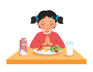 Cute little girl praying before eating breakfast at the table