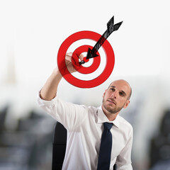 Businessman drawing a target with the arrow. Outline your goals concept