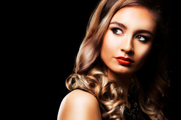 beautiful woman with dark makeup and red lipstick posing on black background