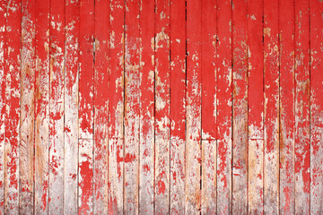 Texture of ancient wood with cracked paint of red color
