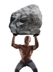 Muscular man with determination lifts a big boulder © Designpics