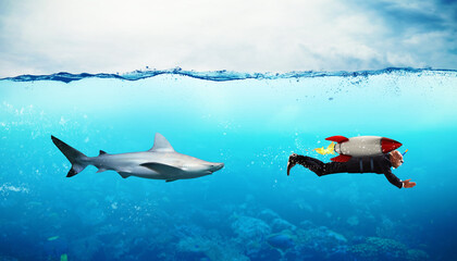 Concept of competition with businessman who escapes from sharks with rocket
