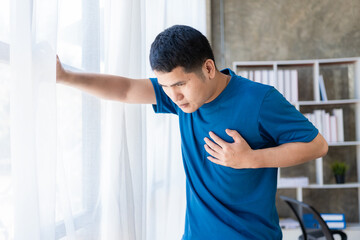 Man suffering from chest pain heart attack or cramps Chest press in pain gesture, heart disease...